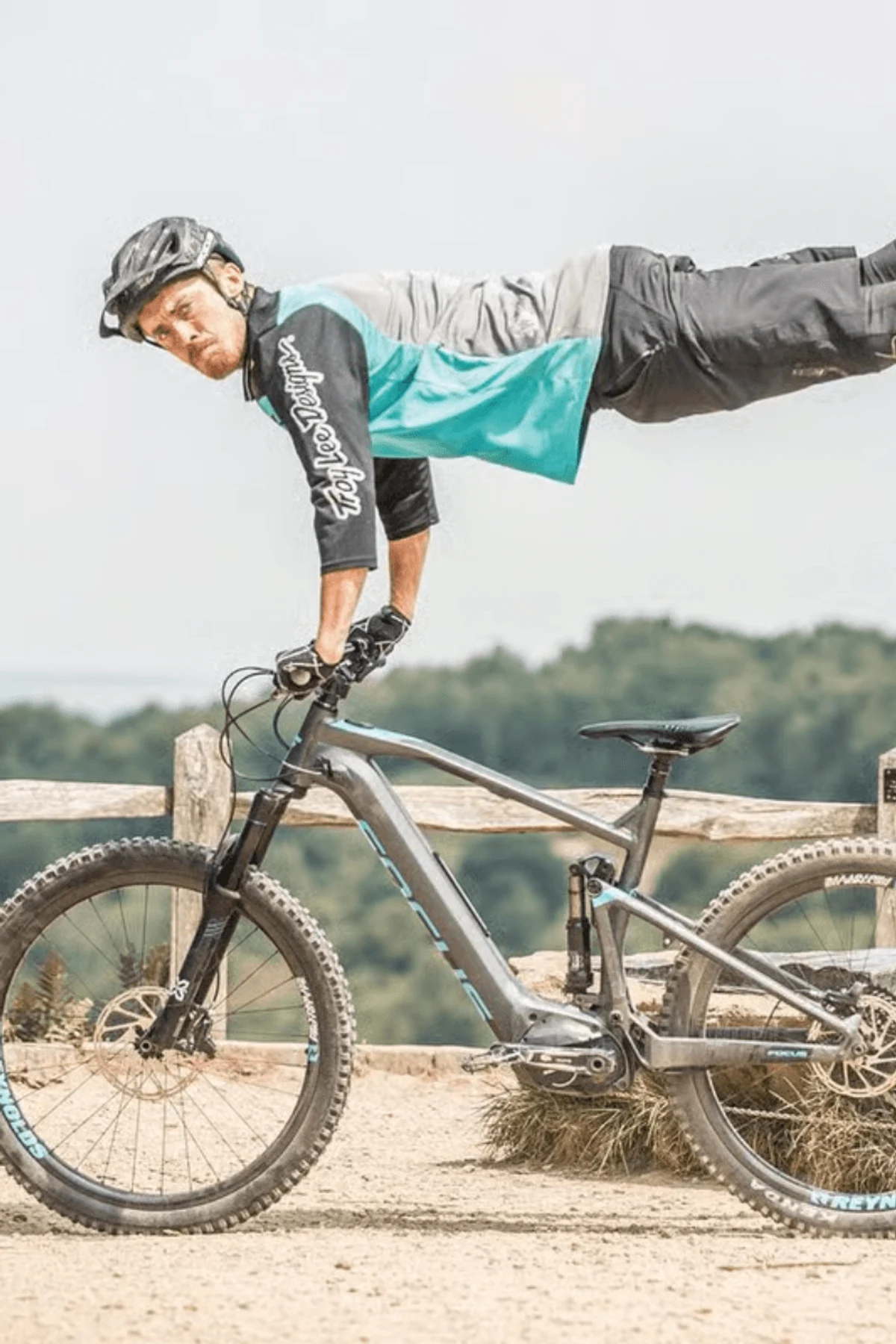 Man standing with bike on Plaza in front of building 